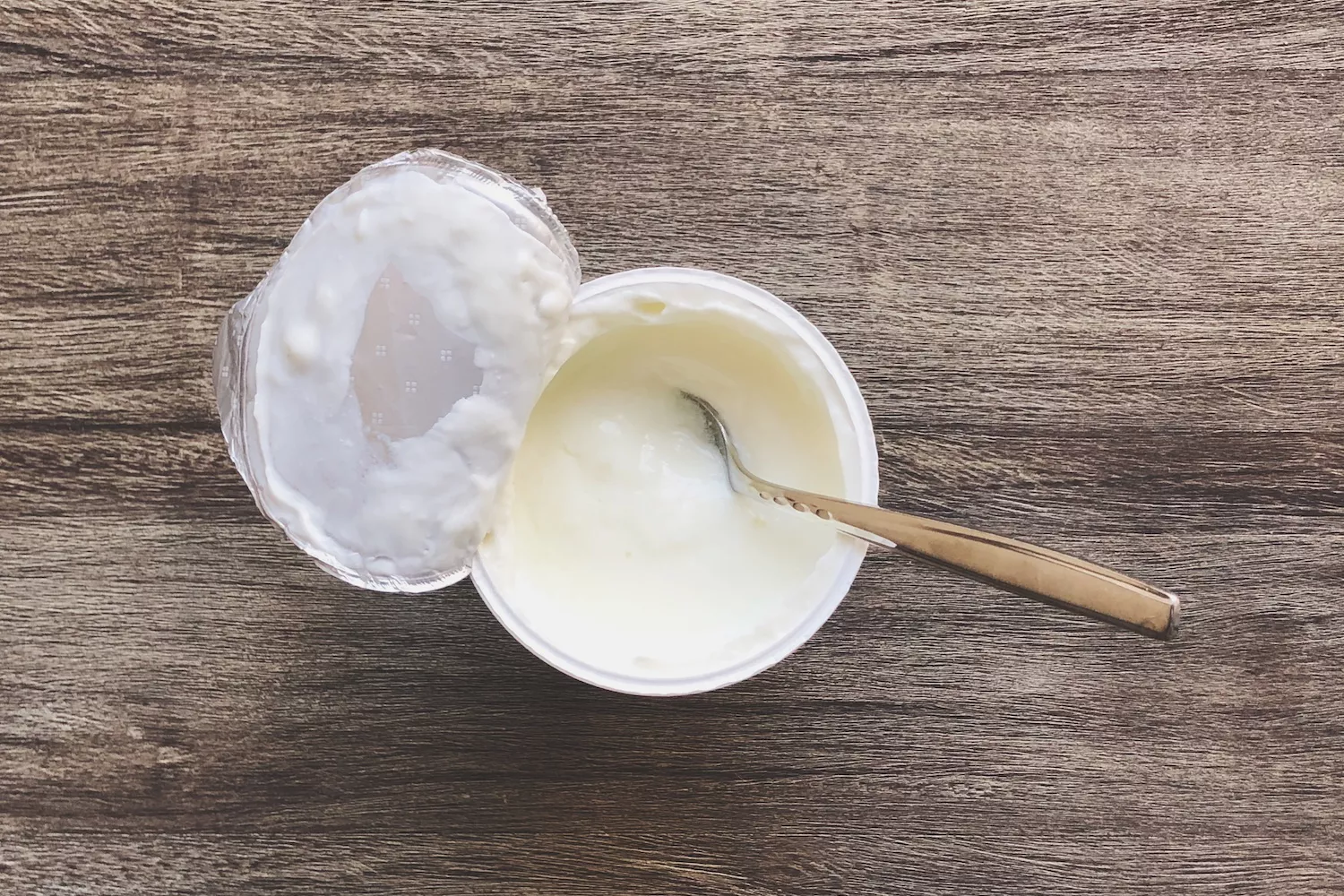 a cup of yogurt on wood